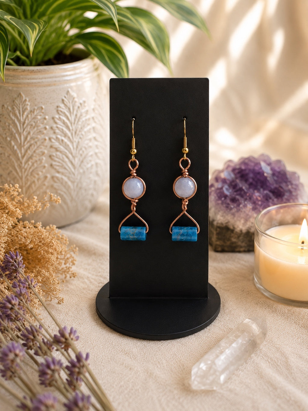Copper and blue bead earrings styled with amethyst, quartz, dried flowers and candlelight