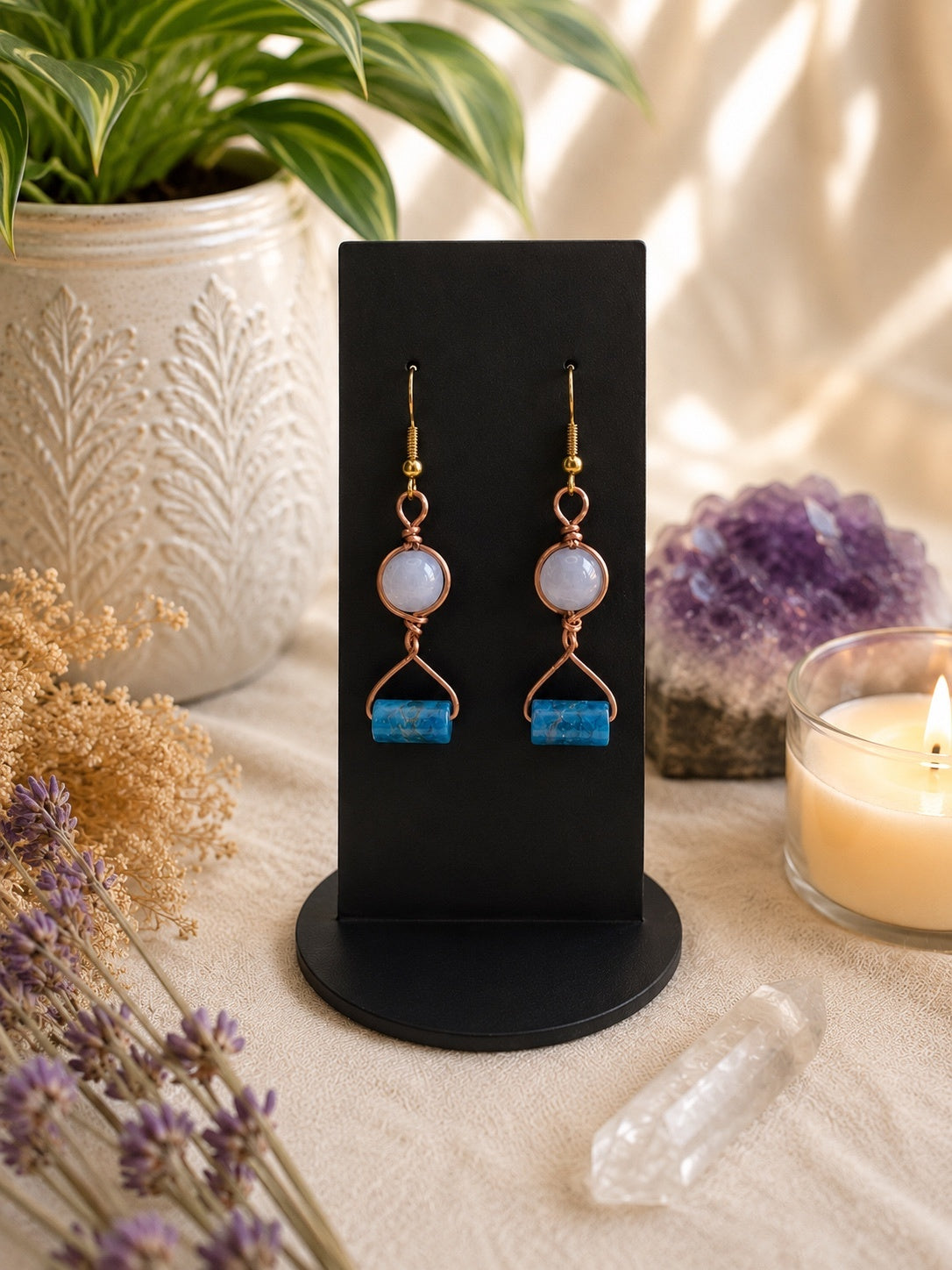 Copper and blue bead earrings styled with amethyst, quartz, dried flowers and candlelight